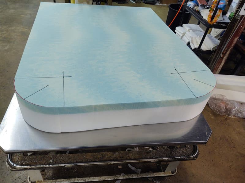 Mattress foam cut to an Airstream's rounded corners in the workshop